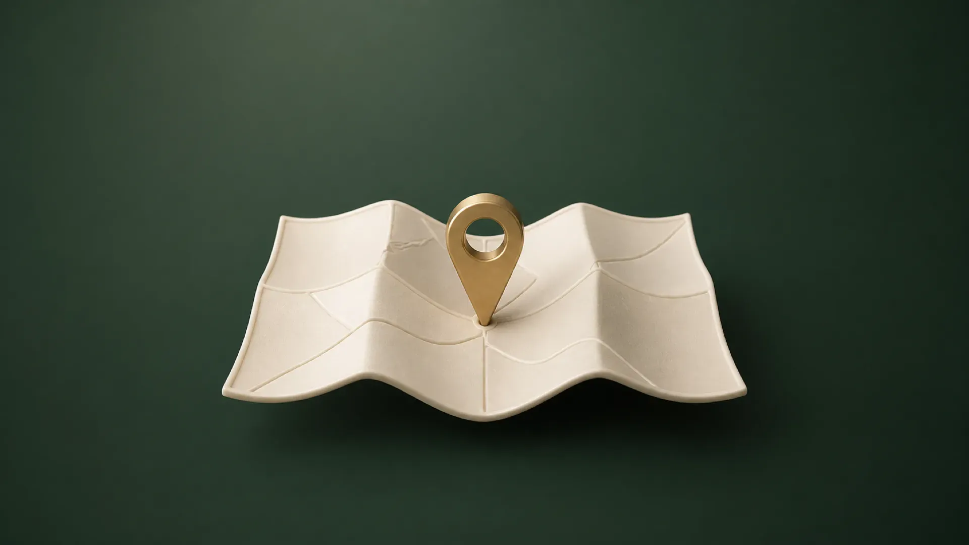Illustration of a folded cream ceramic map with a brass location pin on a deep eucalyptus-green background.